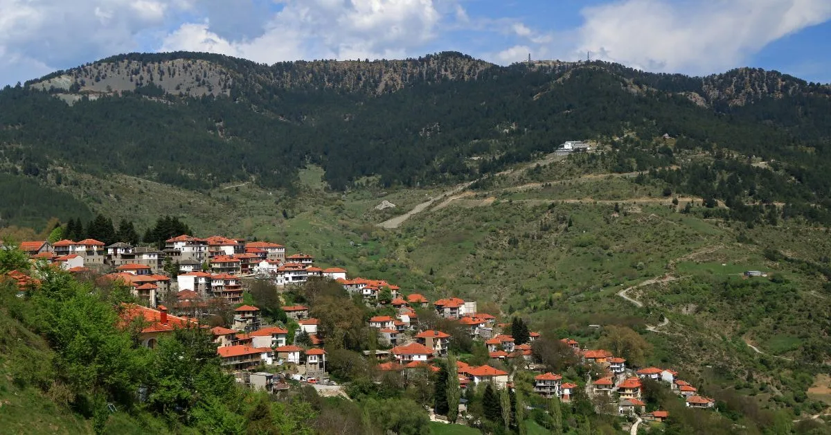 aerial view of Metsovo village for afar with a mountain in the background during the day