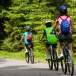 realistic photo of a three people riding a bicycle in a forest road